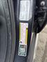 A close-up of the door frame of a 2015 Dodge Durango showing various informational and safety stickers