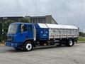 A blue 2017 Autocar Xpert truck with a silver rear cargo bed and a large covered compartment for transporting materials