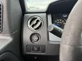 Interior dashboard of a 2014 Ford F-150 showing air vent light control knob and dashboard gauge with speedometer and indicator lights