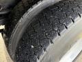 Close-up of a tire on a 2011 International WorkStar showing deep tread patterns and a well-worn surface