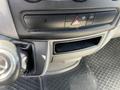 A close-up of the dashboard controls of a 2016 Mercedes-Benz Sprinter featuring buttons for hazard lights and other functions
