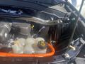 The engine compartment of a 2020 Ford Explorer showing various components including a coolant reservoir and hoses