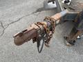 Close-up view of a rusty hitch on a 2013 JLG Industries Flat Deck Trailer with a chain attached