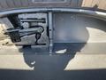 A 2018 Hyundai Santa Fe trunk with space for storage and a black folding chair or tool set on the left side