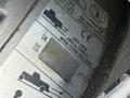 A close-up of a vehicle identification label showing specifications for a 2015 Freightliner M2 including weight limits and serial number details