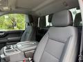 Interior of a 2019 Chevrolet Silverado 1500 featuring two front seats and a center console with storage compartments