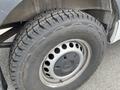 A close-up view of a 2025 Mercedes-Benz Sprinter's tire featuring an all-terrain radial SL369 AT tread pattern and a robust steel wheel design
