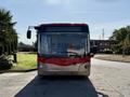A 2016 Grande West Vicinity bus with a red front, large windows, and a prominent driver's side mirror facing forward