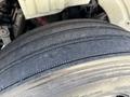 Close-up of a worn tire from a 2010 Freightliner M2 106 showing visible tread wear and tire surface details