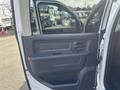 A 2012 RAM 2500 vehicle door with a black interior panel and controls visible, showcasing the handle and window controls