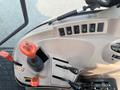 Interior controls and joystick of a 2010 Kubota M6040 tractor featuring various switches and levers for operation