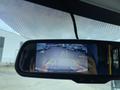 A rearview mirror display showing a backup camera view with parking guidelines for a 2020 Chevrolet Express