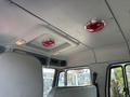 Interior view of a 1999 Freightliner FL80 cab showing the ceiling with circular red lights and fabric-covered overhead panels