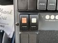Control buttons on the dashboard of a 2020 Mercedes-Benz Sprinter 2500 featuring red and white toggle switches