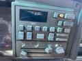 A 1996 GMC Top Kick dashboard control panel featuring various buttons for audio settings and climate controls