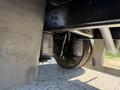 Close-up view of the suspension system featuring air springs and a tire on a 2013 International CE300 truck