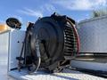 A 2009 Ford F-550 with a mounted black air compressor featuring red hoses and a metallic finish