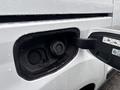 A close-up of the fuel cap area on a 2019 Ford Transit Connect showing the cap and opening with water droplets on the surface