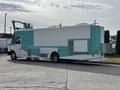 A 2020 Freightliner MT45 vehicle with a predominantly white and teal exterior design featuring multiple windows and exterior vents