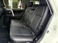 Interior view of the backseat of a 2018 Toyota 4Runner featuring black leather seats with a spacious layout