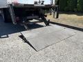 A metal loading ramp is extended from the rear of a 2020 Hino 338 truck designed to assist in loading and unloading heavy items