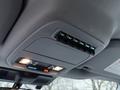 A ceiling control panel in a 2023 Ford F-250 featuring multiple switch buttons for auxiliary functions and two lights