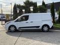 A white 2020 Ford Transit Connect van is parked side view showcasing its compact design and sliding side door with black trim accents