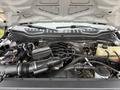 The image shows the engine compartment of a 2020 Ford F-550 with visible components such as the air intake duct battery and various hoses and reservoirs