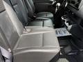 A 2022 Mercedes-Benz Sprinter van interior with black leather seats and a dashboard featuring controls and cup holders