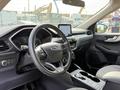 Interior of a 2020 Ford Escape showing the steering wheel dashboard and center console with a touchscreen display
