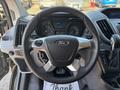 The steering wheel and dashboard of a 2016 Ford Transit 150 with various instrument cluster displays and controls for the vehicle