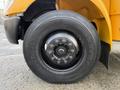 Close-up of the tire on a 2013 International 4300 truck featuring a black Continental MSR2 tire with multiple bolts on the rim