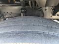 Close-up of the tire of a 2004 Ford F-750 showcasing tread pattern and vehicle detailing
