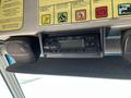 A vehicle's interior dashboard featuring a car stereo and two speakers mounted above the dashboard