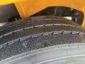 Close-up of a treaded tire from a 2013 International 4300 with visible water droplets on the surface