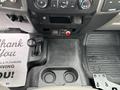Interior view of a 2018 Ford F-550 featuring a gear shift console cup holders and control knobs