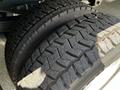 Close-up of two large tires with rugged tread patterns from a 2016 Ford F-550 showing significant wear and depth