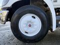 Close-up of a tire on a 2015 Hino 358 featuring a white rim and black tread with the text Long Haul on the sidewall