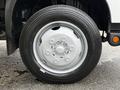 A close-up of the front wheel of a 2019 Hino 195 showcasing a silver rim and a black tire with visible tread patterns