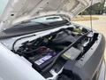A 2008 Ford Econoline engine with the hood raised showing various components including the battery and wiring
