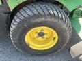 Close-up of a yellow wheel with a thick tread pattern from a 2016 John Deere 1585 Terrain Cut machine