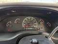 Dashboard of a 2002 Ford Econoline showing speedometer fuel gauge temperature gauge and warning lights