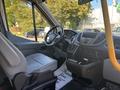 Interior of a 2017 Ford Transit-350 showing the driver's seat dashboard and steering wheel