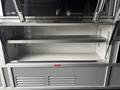 An open compartment in a 2020 Mercedes-Benz Sprinter 2500 with a metal shelf and a clean interior design