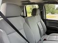 Interior view of a 2018 Chevrolet Silverado 1500 featuring gray fabric seats and seat belts, with a focus on the front seating area