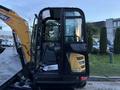 A 2023 Sany SY35U excavator with a black cab featuring glass panels and a yellow arm is shown in the foreground