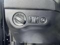 Dashboard controls of a 2015 Dodge Charger including a headlight switch and other adjustable buttons