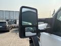 A side mirror of a 2009 Ford F-550 showing a dual mirror design with a large main mirror and a smaller convex mirror for a wider view