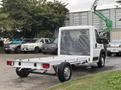 A white 2023 RAM Promaster 3500 chassis cab with a flatbed, displaying the cab area and open cargo space at the rear