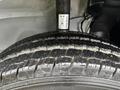 Close-up of the tire of a 2023 RAM Promaster 3500 showcasing tread patterns and details of the rubber surface